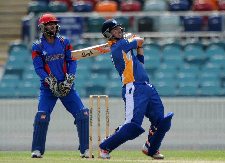 IT’S GONE: Comets batsman Andrew Harriott hits a six for the ACT side which is skippered by Bathurst talent Jono Dean. The Comets lost Friday’s match against Afghanistan in a final over thriller. Photo: Graham Tidy