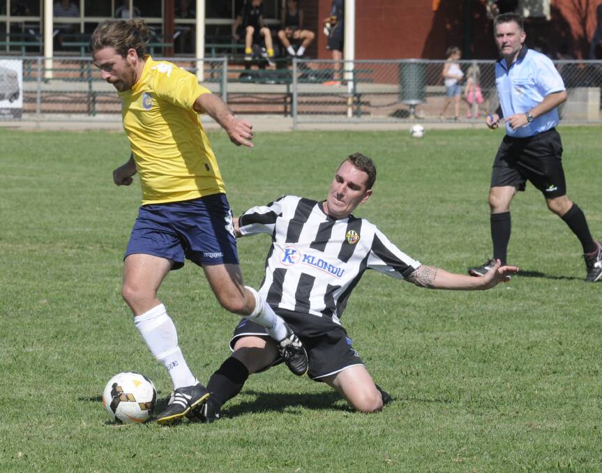 CONFIDENCE BOOSTER: Craig Sugden (left) in action for the Western NSW Mariners FC side during their trial with Port Kembla on Saturday. Photo: CHRIS SEABROOK	 022815csocr1