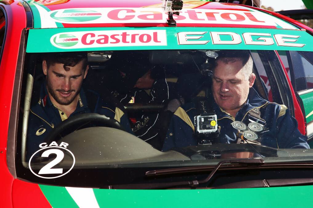 REVVED UP: Wallabies hooker Nathan Charles (left) and national coach Ewen McKenzie check out a V8 Supercar at Mount Panorama on Wednesday. The pair were in Bathurst as part of the Bush2Bledisloe tour. Photo: GETTY IMAGES