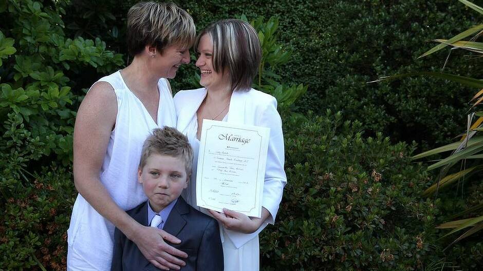 Samantha Harmes, Haley Wilson and 7-year-old Bailey (Samantha's son) pose for photos with the wedding certificate after their ceremony. Photo: Alex Ellinghausen