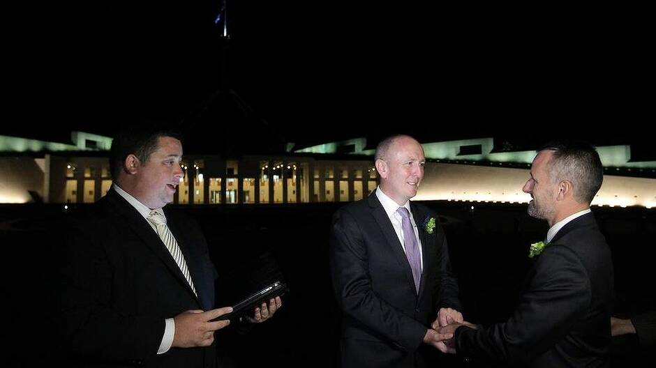 Stephen Dawson and Dennis Liddelow getting married shortly after midnight, in front of Parliament House in Canberra. Photo: Alex Ellinghausen
