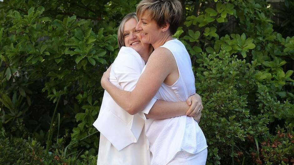Samantha Harmes and Haley Wilson hug after getting married. Photo: Alex Ellinghausen