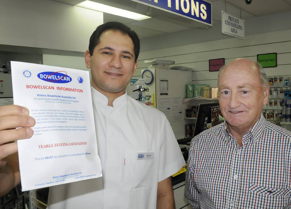 RIGHT TIME: Westpoint Centre Pharmacy’s Rami Edward and Bathurst East Rotary Bowelscan co-ordinator Brian Burke with a Bowelscan test kit. Photo: CHRIS SEABROOK 	060214cbowel