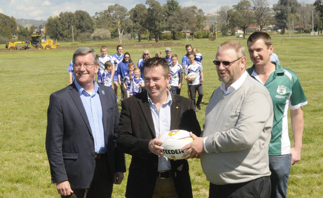 FIELD OF DREAMS: Bathurst mayor Gary Rush, Member for Bathurst Paul Toole, St Pat’s Rugby League seniors secretary Gary Goldsmith and Western NSW Country Rugby League regional manager Peter Clarke, along with current players, celebrate a $75,000 funding announcement for the club. Photo: CHRIS SEABROOK 	092115cpats