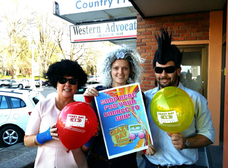 HAIR-RAISING: Western Advocate media consultants Catherine Miles, Kathleen Gracey and Martin Russell get in the mood for Crazy Day on Thursday. This year’s theme is the awesome 1980s.	 091214crazyday
