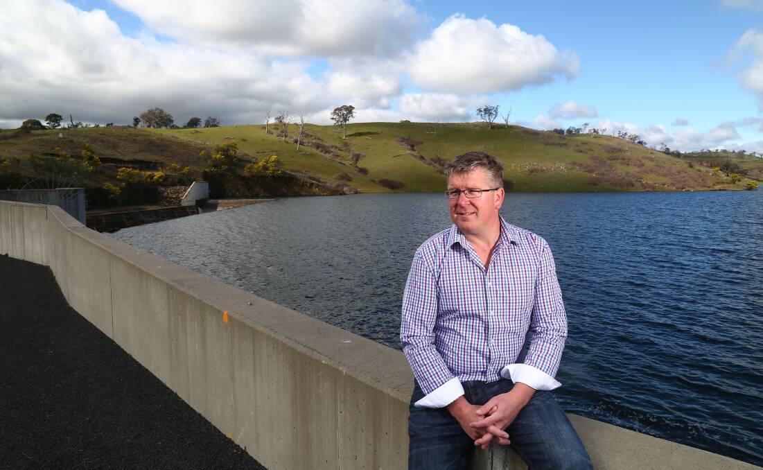 BETTER DAYS: Bathurst Regional councillor Michael Coote at the Chifley Dam spillway when the dam was at 100 per cent capacity in August last year. Photo: PHIL BLATCH 082615pbdam9