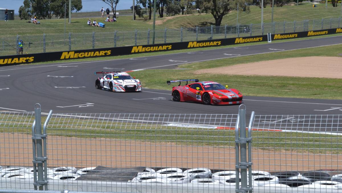 FLYING: Christopher Mies’ Audi R8-LMS (left) follows a rival into Pit Straight during practice yesterday at the Bathurst 12 Hour. Photo: SAM DEBENHAM 	020516sd12hr