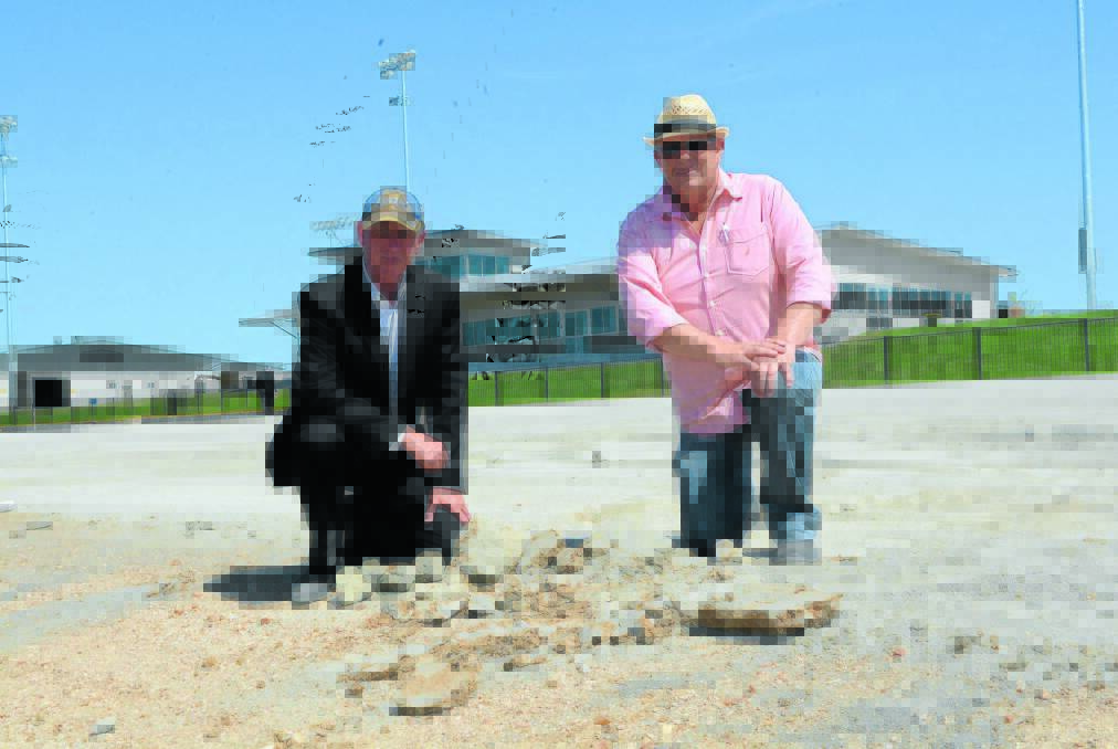 SORTING IT OUT; Bathurst Harness Racing Clubs CEO Danny Dwyer and president Mark Collins near the sprint lane, the area most affected by a soft surface at the Bathurst Paceway. Photo: PHILL MURRAY 102214ptrack2