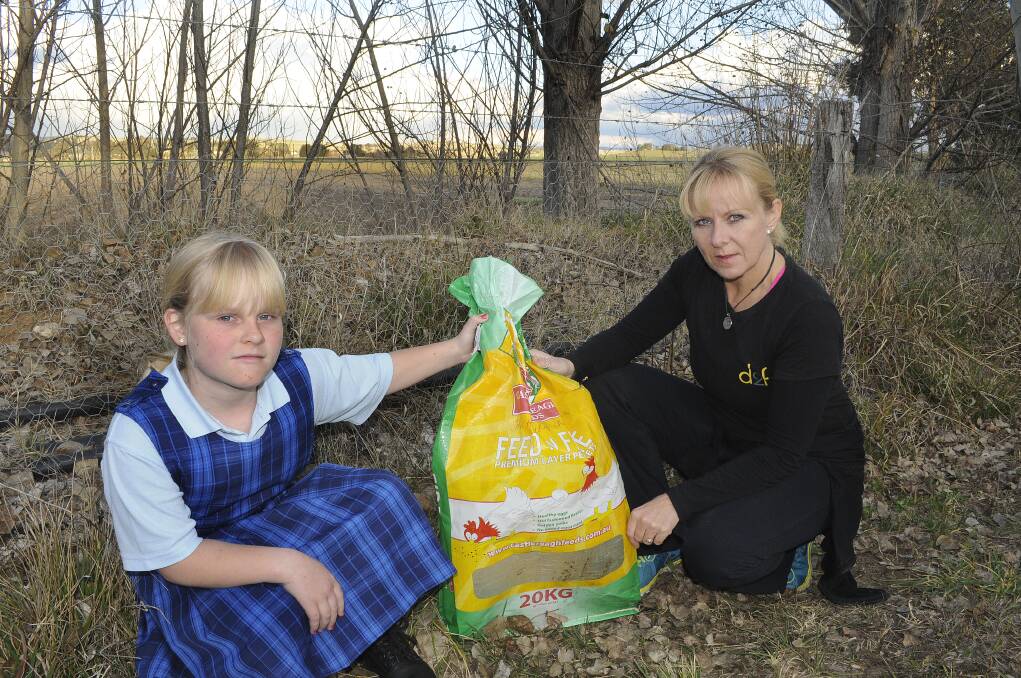 HEARTBREAK: Charlotte Glen and her mum Bev were left upset after someone dumped a rooster in this thick plastic bag to die out the front of their Gormans Hill Road property. Photo: CHRIS SEABROOK 	082514cfowel