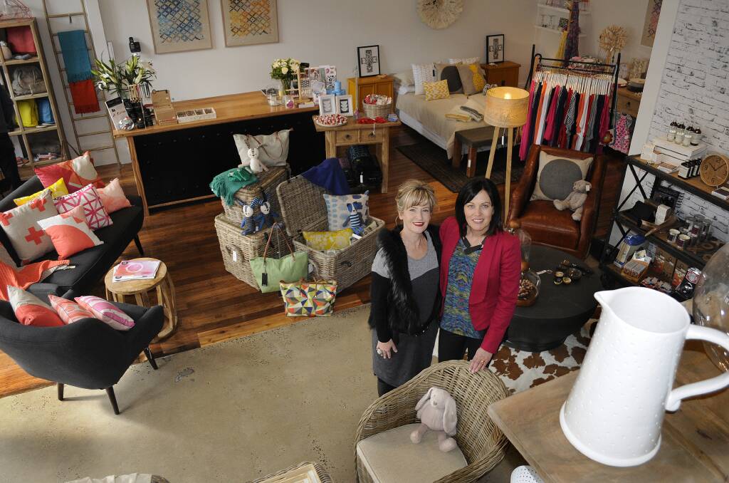 LOOKING UP: Bronwyn Aberley and Kate Hemsworth in their new shop. Photo: CHRIS SEABROOK 	081814cgeorg