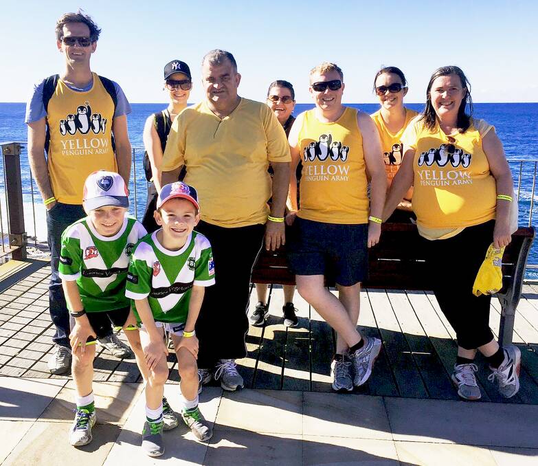 YELLOW ARMY: Bathurst couple Geoff Bottom (standing, third from left) and his wife Helen Bottom (far right), along with fellow walkers, travelled to Sydney on Sunday to take part in a fundraising walk for the Children’s Tumour Foundation of Australia. Photo: SUPPLIED 053016walk