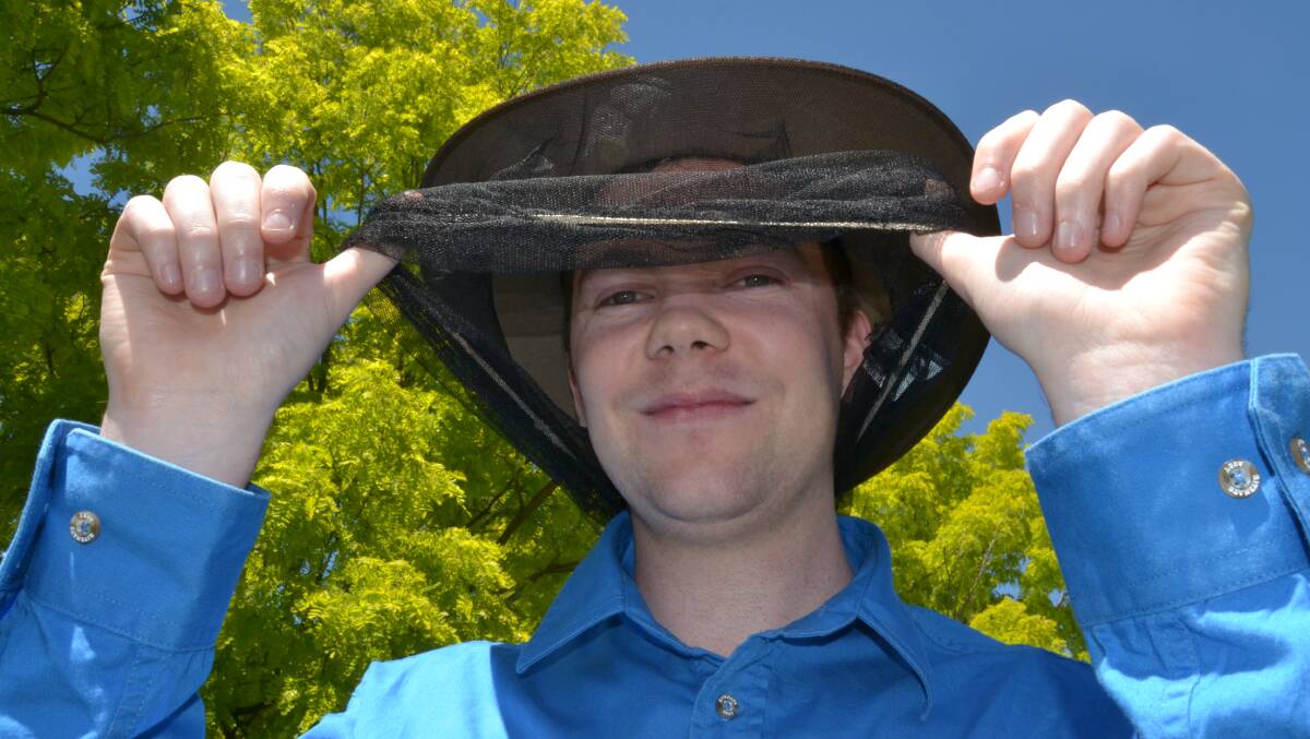 UNDER THE VEIL: Matthew Smith from Frank Smith Work Clothing with a good, old-fashioned fly veil that’s making life tough for those pesky insects that are back out in force thanks to the hot and humid conditions. Photo: BRIAN WOOD	 110915bwfly
