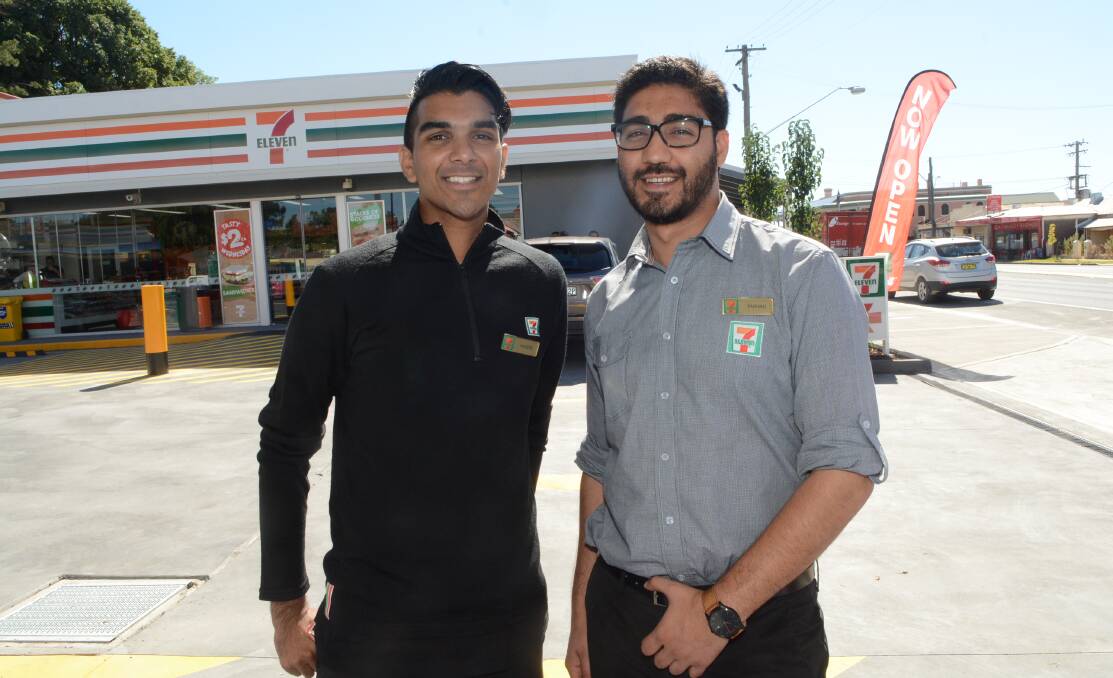 A MATTER OF CONVENIENCE: Haseeb Zagham and Farman Mahmood outside the new 7-Eleven store that opened on Stewart Street yesterday. Photo: PHILL MURRAY 022516p711