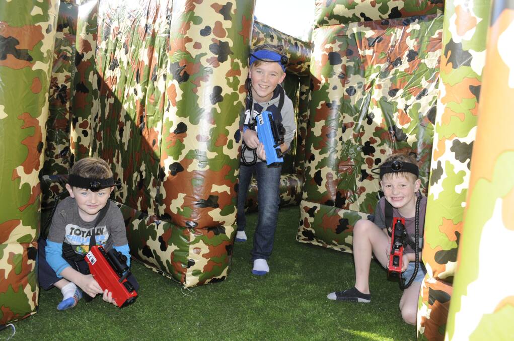 LOCK AND LOAD: Brothers William, 6, and Connor Handel, 12, and Jackson Croucher-Bellamy, 7, try out the new laser tag area at Jumbo’s Jungle. Photo: CHRIS SEABROOK 	062915cjumbos