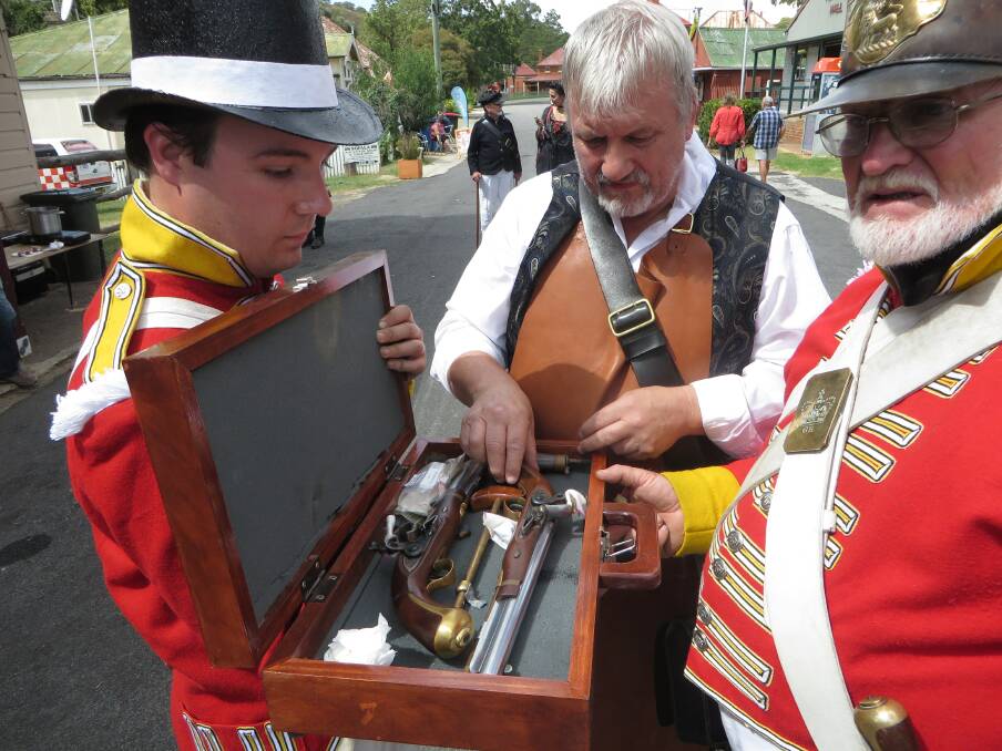 ON DUTY: NSW Corps Marines members Mitchell Sutton, Gavin Jones and Andrew McRae checking out their pistols in preparation for next month’s colonial fair to mark Bathurst’s bicentenary. Photo: SUPPLIED 	042215fair8