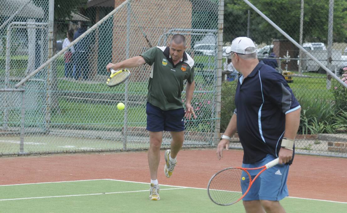 SCRAPING HOME: Christian Dowling lets a backhand go during his team’s win, on countback, in the over 35s tournament on the weekend at the Bathurst Tennis Centre.  Photo; CHRIS SEABROOK 	111515ctenis2