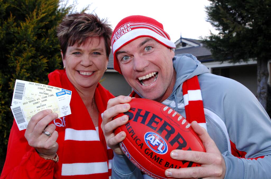 THAT’S THE TICKET: Liz and Mark Kennedy have done the hard yards to be at today’s AFL grand final. Photo: ZENIO LAPKA     	092414zswans