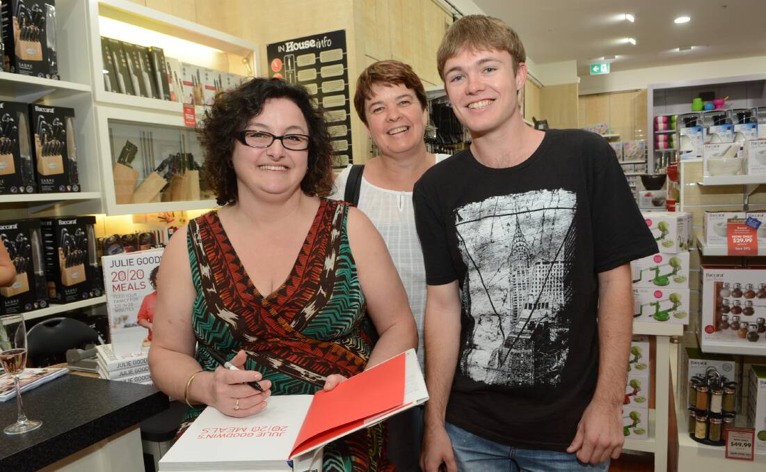 WHAT’S COOKING: Former MasterChef winner Julie Goodwin meets two of her Bathurst fans, Michelle and Ben Wootton, at House yesterday.	 121714phouse