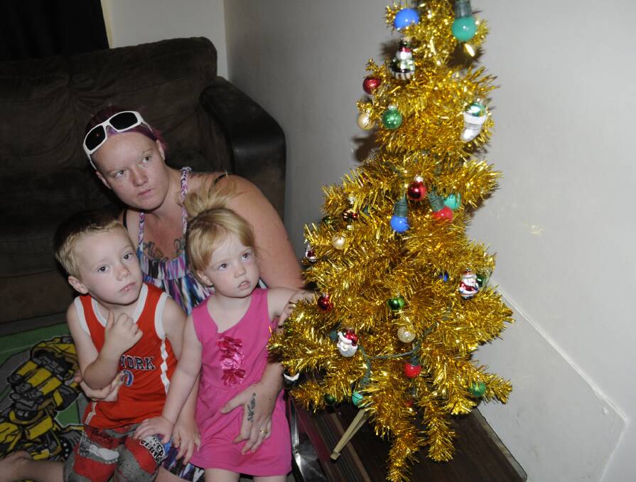 LOW ACT: Kiara White and her kids, B-Jay and Angel, had presents stolen from under their Christmas tree. Photo: CHRIS SEABROOK 	122214ctheft1