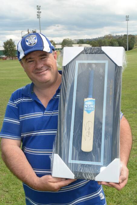 THINK PINK: Luke Abbott with the mini cricket bat which will be auctioned at the Pink Stumps Day fundraiser for the McGrath Foundation next week. Photo: PHILL MURRAY 	020316pabbor