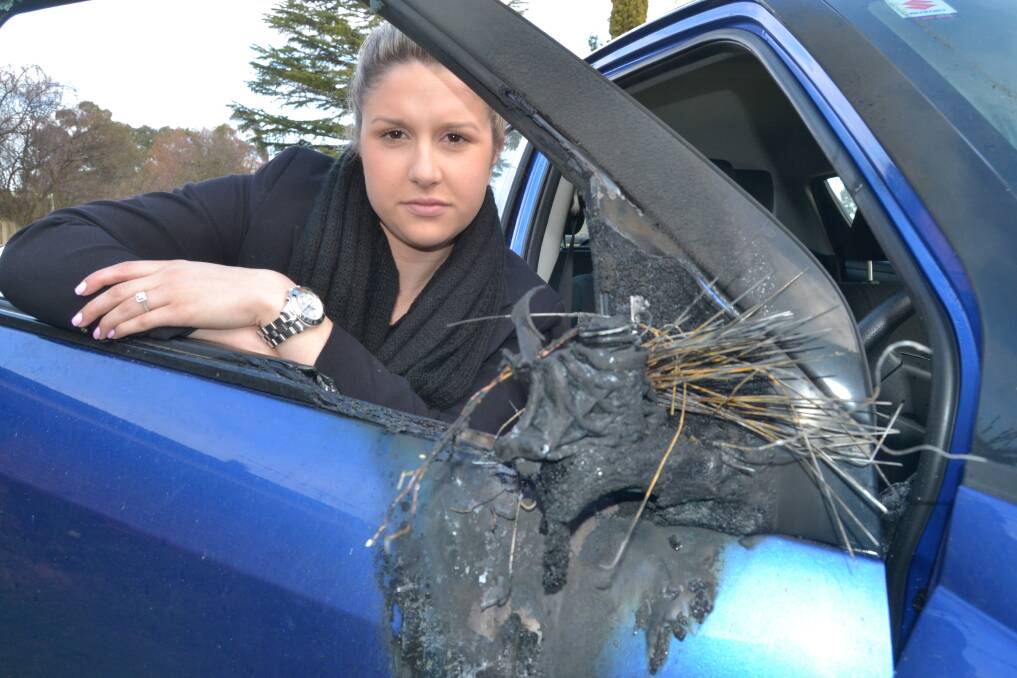 FLAMING IDIOTS: Linnea ten Broke has been left out of pocket after arsonists badly damaged her Suzuki Swift parked in Kelso overnight on Wednesday. Photo: BRIAN WOOD	 082114car