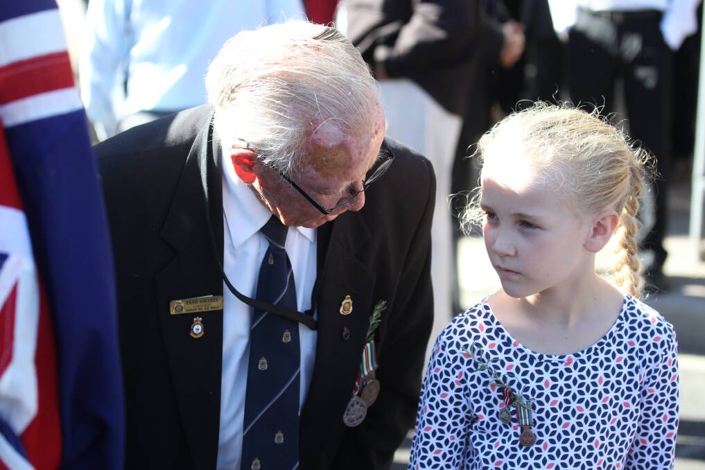 FACES IN THE CROWD: Fred Collett of the Bathurst RSL Sub Branch Committee and his granddaughter Maddie, 7, at yesterday’s Anzac Day service. Photo: PHILL BLATCH  042516pbcollett