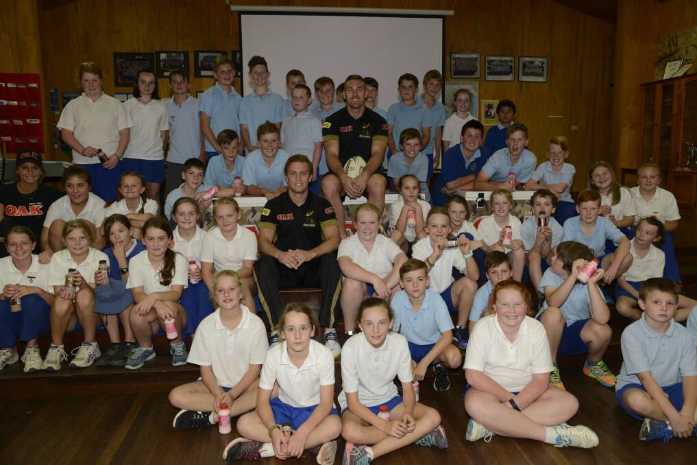 BIG FANS: Penrith Panthers captain Matt Moylan and (rear) second-rower Bryce Cartwright met with year four and six students at Eglinton Public School during a visit yesterday. Photo: PHILL MURRAY 	042816ppanthers1