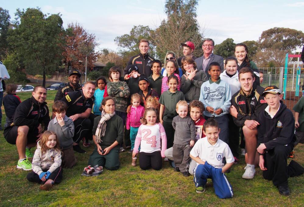 KINGS OF THE KIDS: Panthers stars (from left) Jamie Soward, James Segeyaro, Bryce Cartwright, Matt Moylan and Isaah Yeo with Bathurst mayor Gary Rush and local kids at the Kelso Community Centre yesterday. Photo: ZENIO LAPKA 	072414zleague