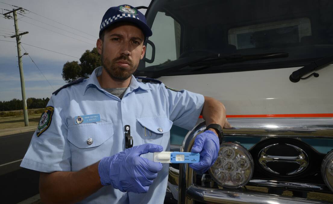 OPERATION SATURATION: Senior Constable Jason Marks with the drug-testing truck in Bathurst yesterday. 	040716pjason