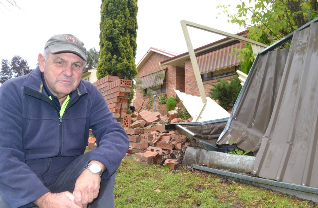 NOT AGAIN: Rocket Street resident David Bullock outside his home yesterday after his front fence had been smashed by a wayward vehicle – again. Photo: BRIAN WOOD 042015bwfence1