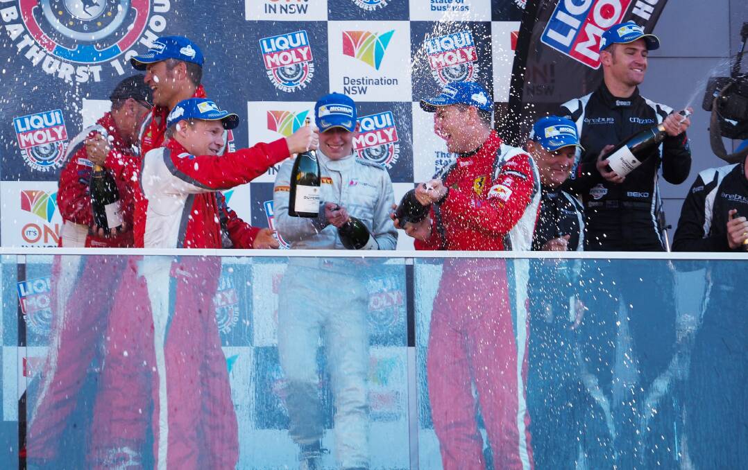 STARS STRUCK: Champion V8 Supercars driver Craig Lowndes (right, pictured celebrating this year’s Bathurst 12 Hour victory) says it would be disappointing if next year’s event clashed with a compulsory test day for V8 drivers. Photo: ZENIO LAPKA 	020914zmoly33