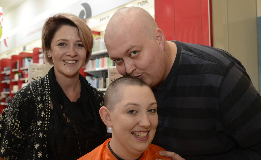 SUPPORT: Clare Strik has had her head shaved to support her partner Luke Harrison, who was recently diagnosed with cancer. Sophia Perry did the honours at Price Attack on Saturday. Photo: PHILL MURRAY 	041616phair