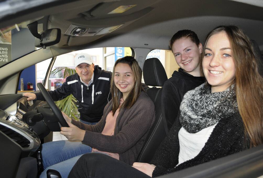 READY TO ROLL: Road safety expert Matt Irvine and learner drivers Jenna Donno, Rosie Hogan and Leah Pentecost check out some of the cars P-platers will soon be able to drive. Photo: CHRIS SEABROOK 	070614cturbo