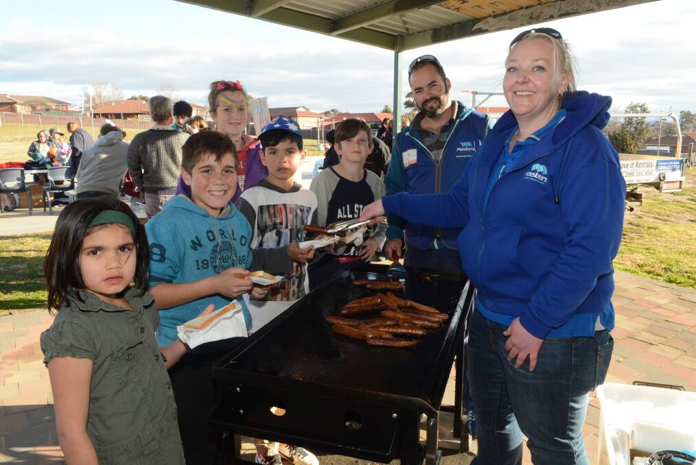 RAISING AWARENESS: Children and adults were able to enjoy a barbecue lunch at yesterday’s Homeless Hub hosted by Wattle Tree House at Kelso Community Centre. Photo: PHILL MURRAY	 080415pkelso2