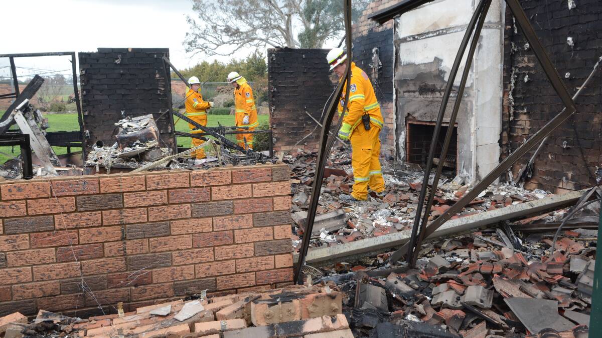 DESTROYED: Police are treating a fire that destroyed a house outside Bathurst yesterday as suspicious. NSW Rural Fire Service crews were still on the site yesterday afternoon ensuring that hot spots in the fire had been extinguished. Photo: PHILL MURRAY 	090315pfire2