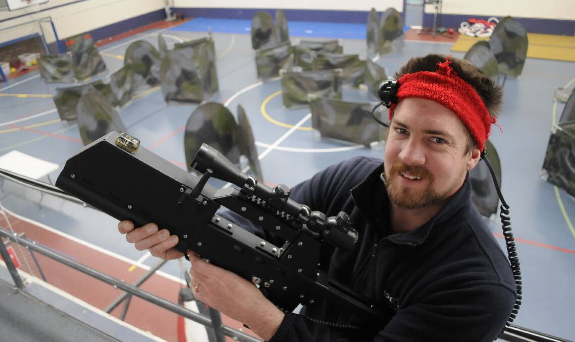 ON TARGET: Bathurst PCYC general manager David Hitchick with one of the laser skirmish rifles which have proved successful at the club. Photo: CHRIS SEABROOK	 090215cpcyc