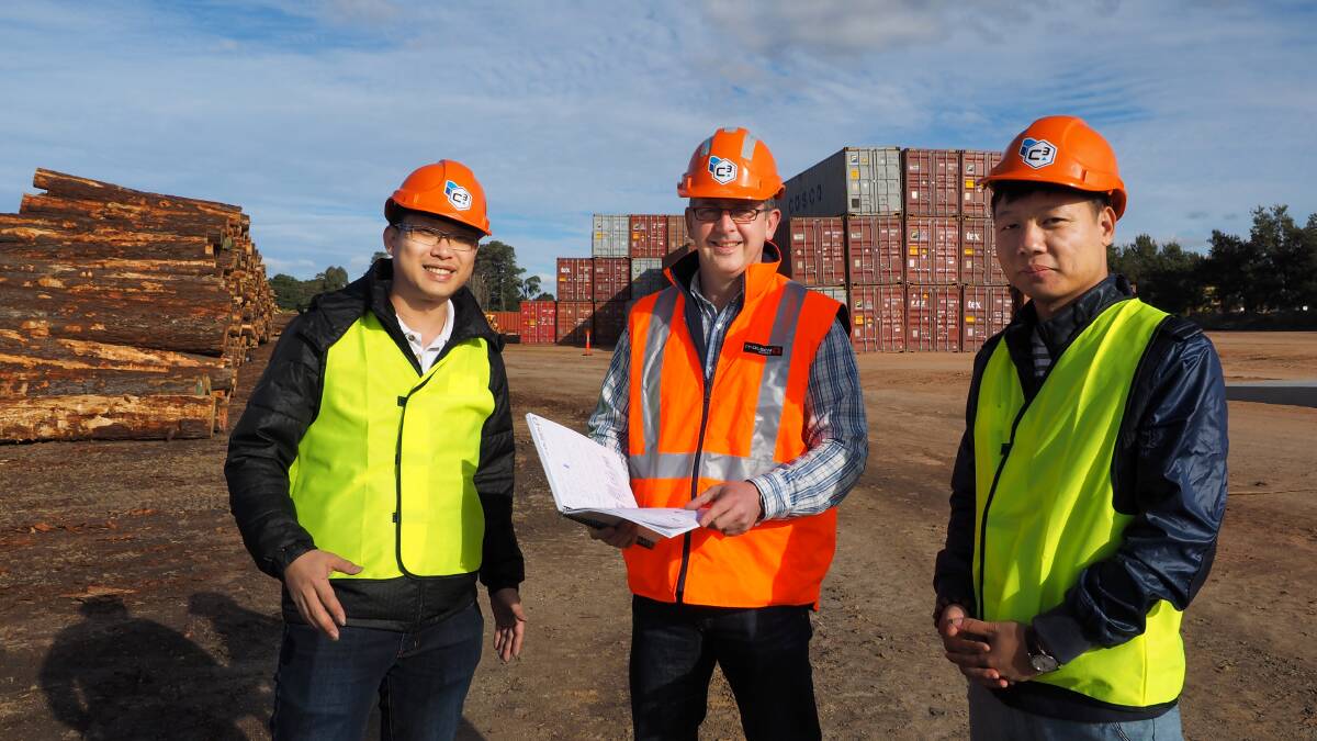 EXPORTS RECOGNISED: Jimmy Lee of Cintac Timber, PF Olsen Australia managing director Pat Groenhout, and customer Linder Lin of Baiyi Timber Ltd, China at the Kelso freight terminal when operations began earlier this year. 