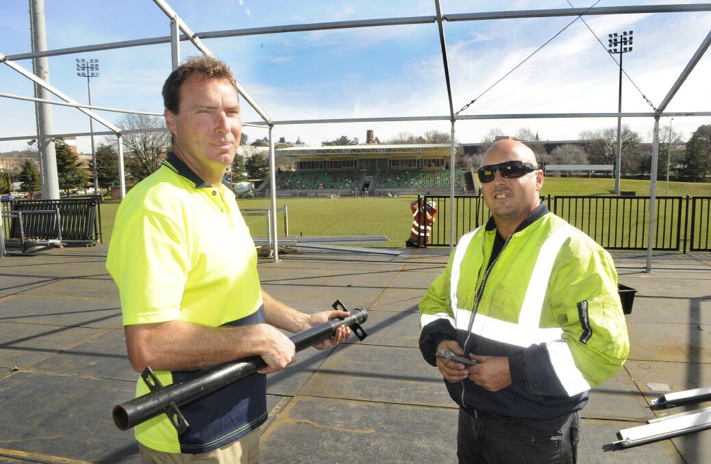ON THEIR GAME: Butlers Events and Staging project managers Martin Webb and Corey Wall work on the scaffold deck and marquee being installed at Carrington Park ahead of the Penrith Panthers and Cronulla Sharks match. Photo: CHRIS SEABROOK 	071414cmarque