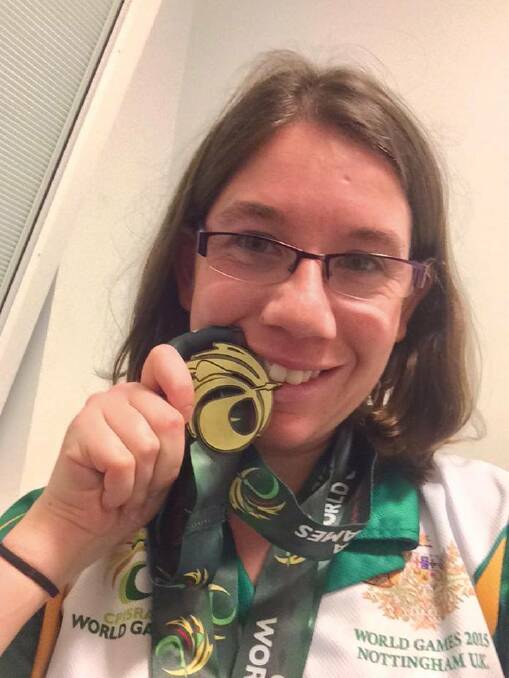 GOLDEN SMILE: Bathurst swimmer Rachel Staines with one of her seven gold medals. 	081715rach