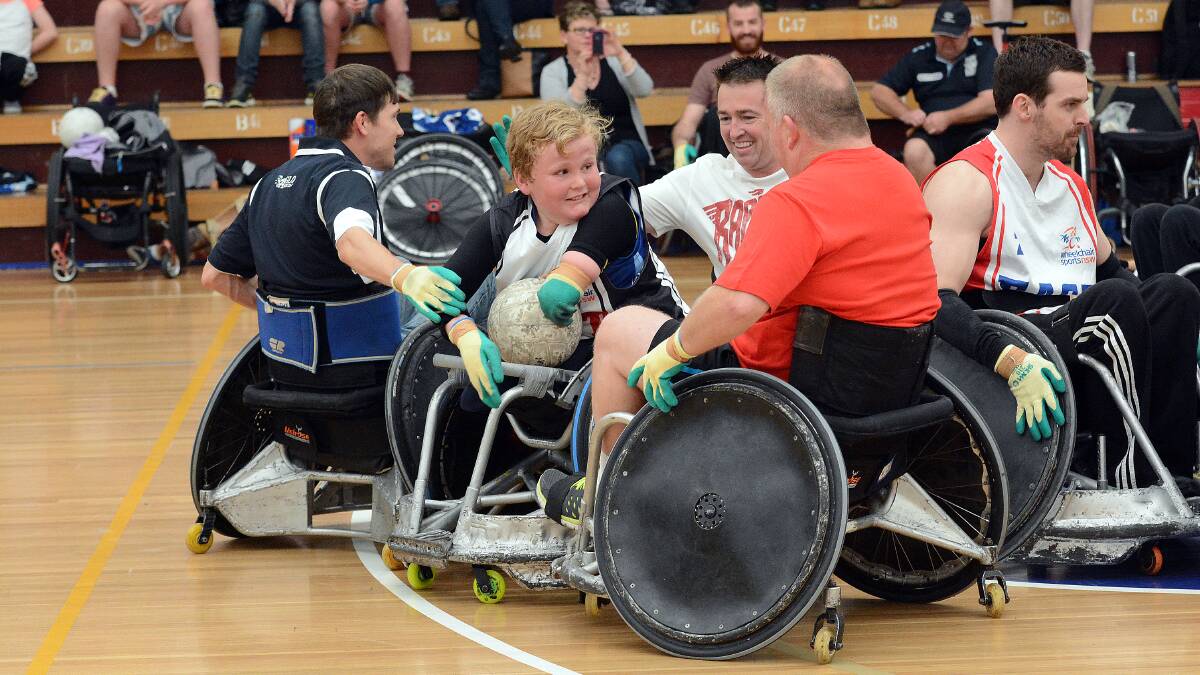 CRUNCH: Harry Clist is surrounded by Member for Bathurst Paul Toole and Mick Whittaker during the Sydney Slam action on Saturday. Photo: PHILL MURRAY 	091314pwheels19