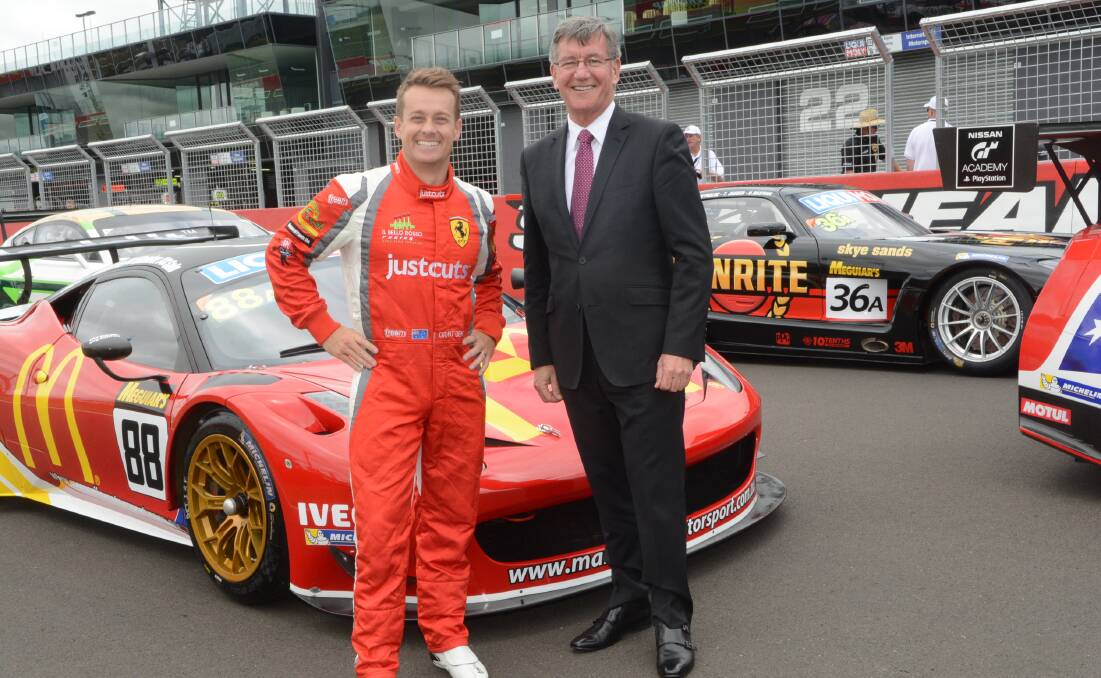 WINNING COMBINATION: Driver Grant Denyer, pictured with mayor Gary Rush on Pit Straight at Mount Panorama, believes he and his team-mates have a good chance of taking out the Liqui Moly Bathurst 12 Hour on Sunday. Photo: PHILL MURRAY 020416pmount3