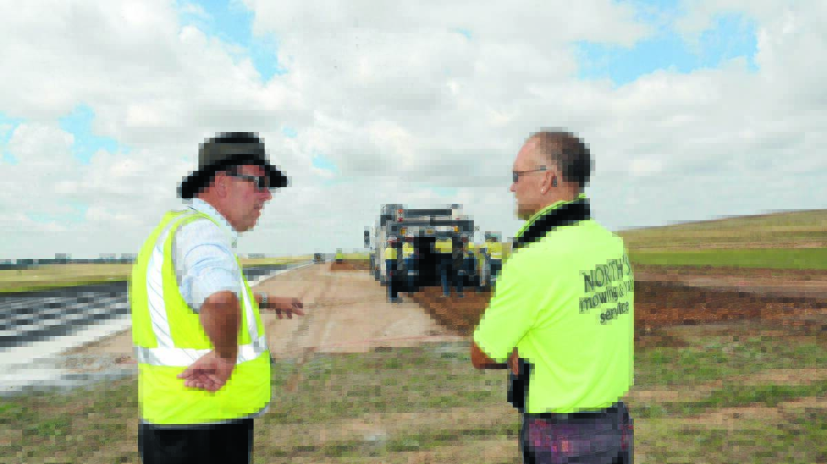 AIRPORT UPGRADE: Darren Sturgiss from Bathurst Regional Council and deputy mayor Ian North were at the Bathurst Airport checking on the initial stages of the $3 million project to resurface the main runway. Photo: PHILL MURRAY 010615pairport