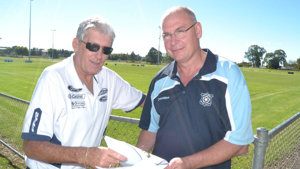 GREAT NEWS: Kelvin Moore and Michael O’Connor from the Bathurst District Football Association at Proctor Park looking over plans to upgrade the complex. 	040915proctor2