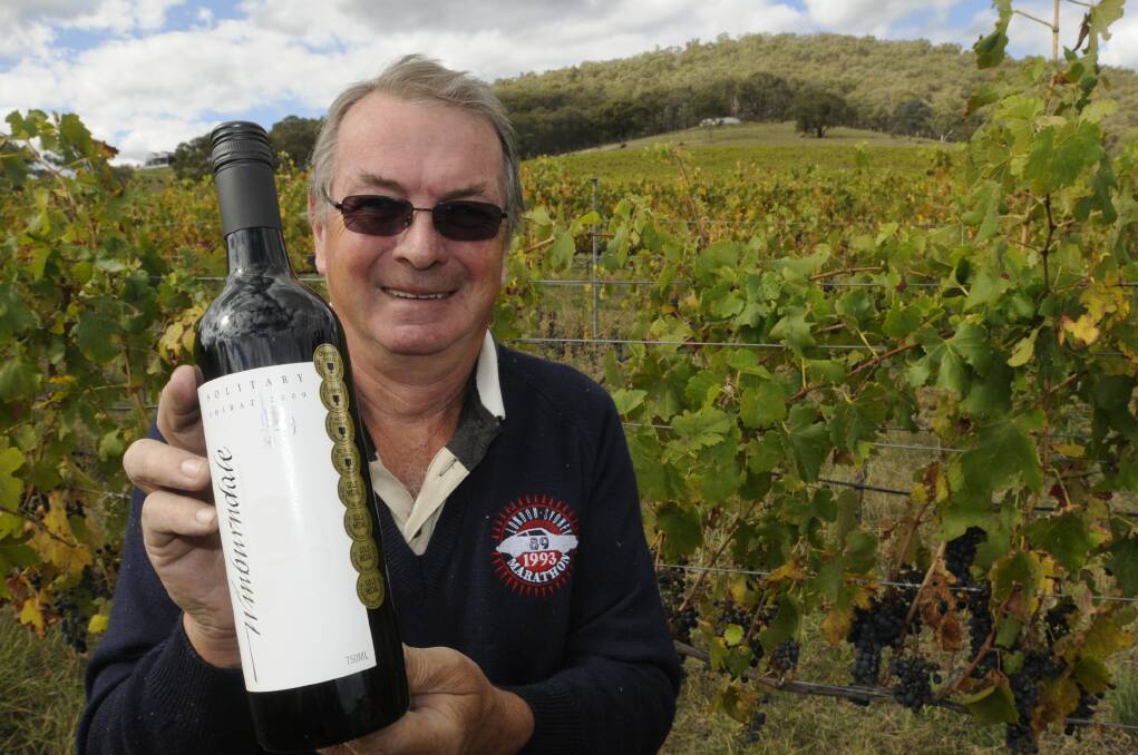 TOP DROP: Winburndale Wines’ Mike Burleigh says the winery’s next harvest is on track to produce some fantastic wines. He is pictured with his multi-award-winning Winburndale 2009 Solitary Shiraz. Photo: CHRIS SEABROOK 	040113ctopdrop