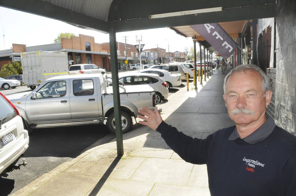 EASE THE CHAOS: Keith Illingworth, who owns Inspirations Paints in Keppel Street, welcomes the introduction of Saturday parking patrols. Photo: CHRIS SEABROOK 	092914cparkn