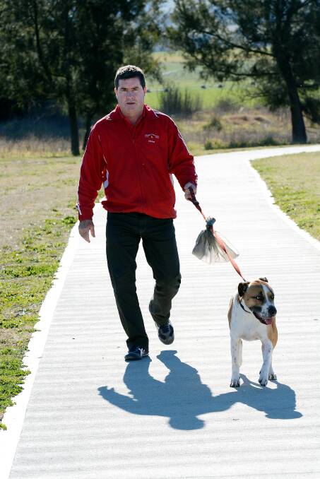 NOT HAPPY: Councillor Warren Aubin, pictured with his dog George, says the Kath Knowles Pathway is being spoiled. Photo: PHILL MURRAY 	070814pwarren