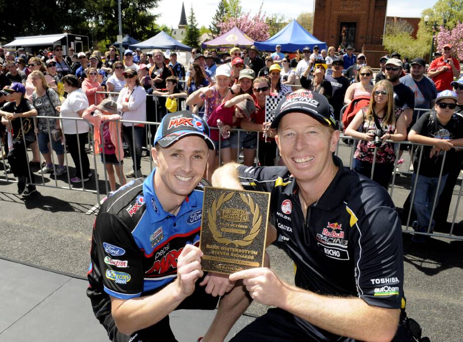 WINNERS: Mark Winterbottom and Steven Richards, 2013 Bathurst 1000 winners, with the plaque that was laid in the pavement outside the council chambers during last year's Bathurst 1000 festivities in the CBD.