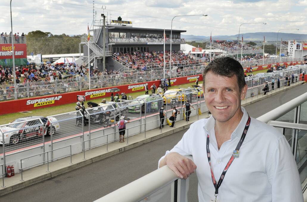 SPECIAL GUEST: NSW Premier Mike Baird above Pit Lane at Mount Panorama yesterday. Photo: CHRIS SEABROOK 	101214cmtp1
