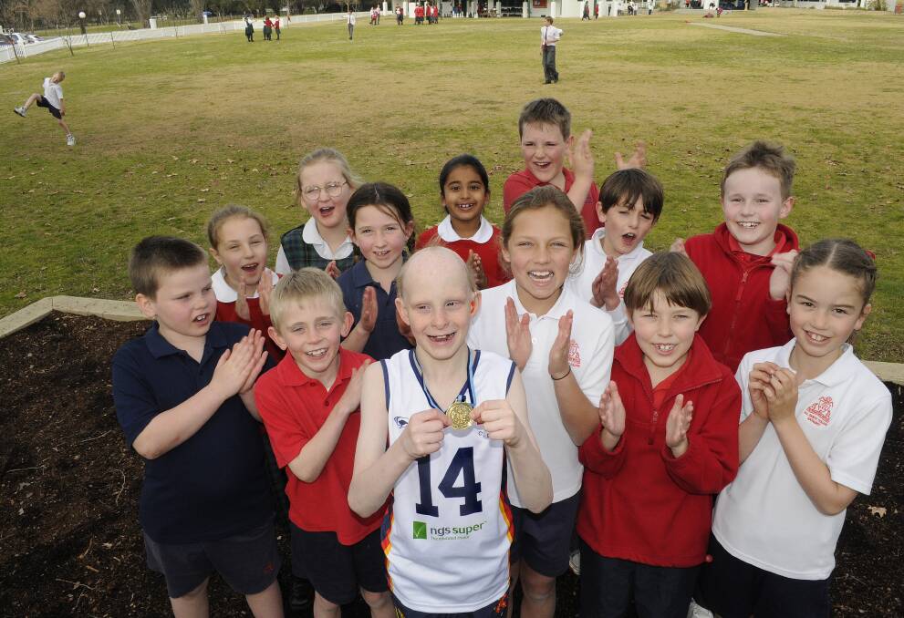 WELL DONE TODD: Todd Nelson, who won a state cross country title, with his class-mates at All Saints’ College Junior School. Photo: CHRIS SEABROOK 	072314cross