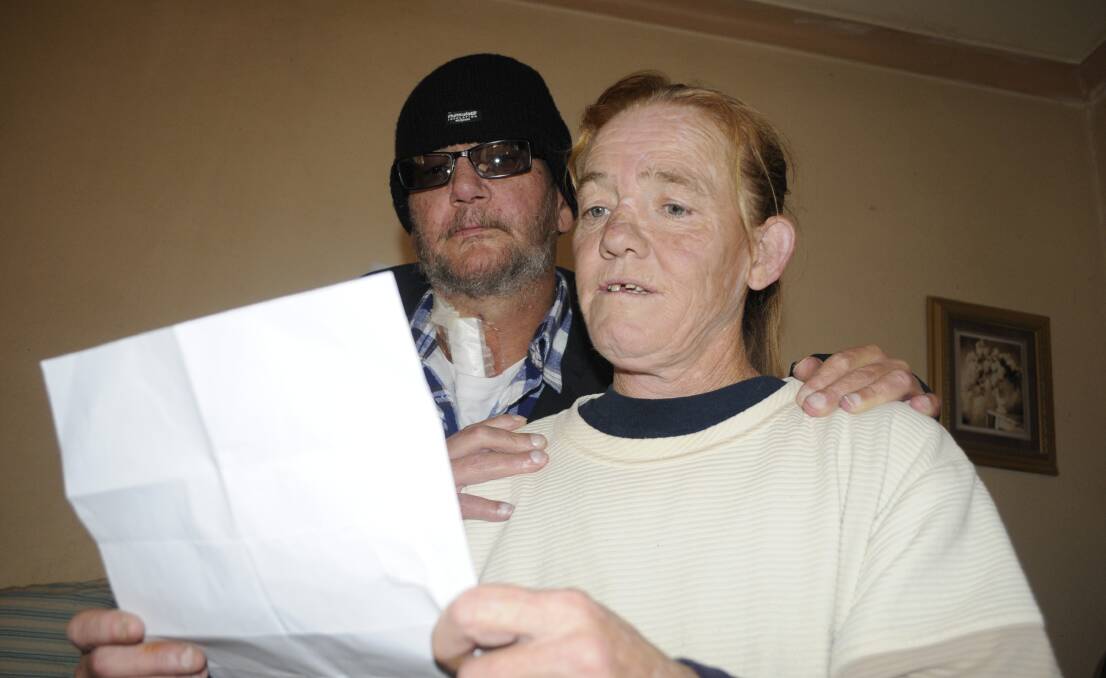 LONG WAIT: Andrew Russell’s father Bruce Herbert and stepmother Suzanne Wallace with the Notice of Inquest from the State Coroner’s Court. Photo: CHRIS SEABROOK 	060716coroner1